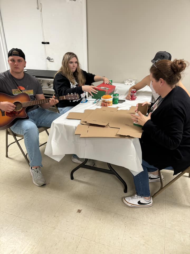 Young musician leading youth fellowship with guitar
